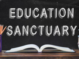 Pencils and books on a desk with text that reads: EDUCATION SANCTUARY