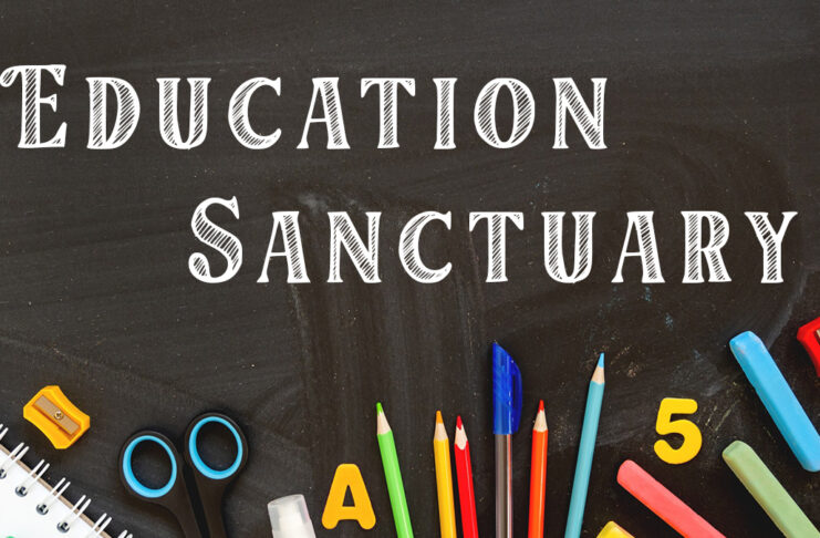 Picture shows a blackboard with the words Education Sanctuary